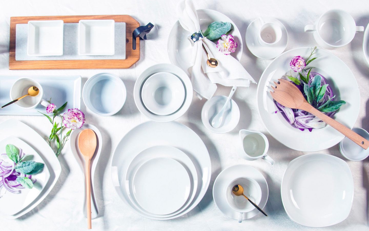 White ceramic tableware and serving pieces flat-lay