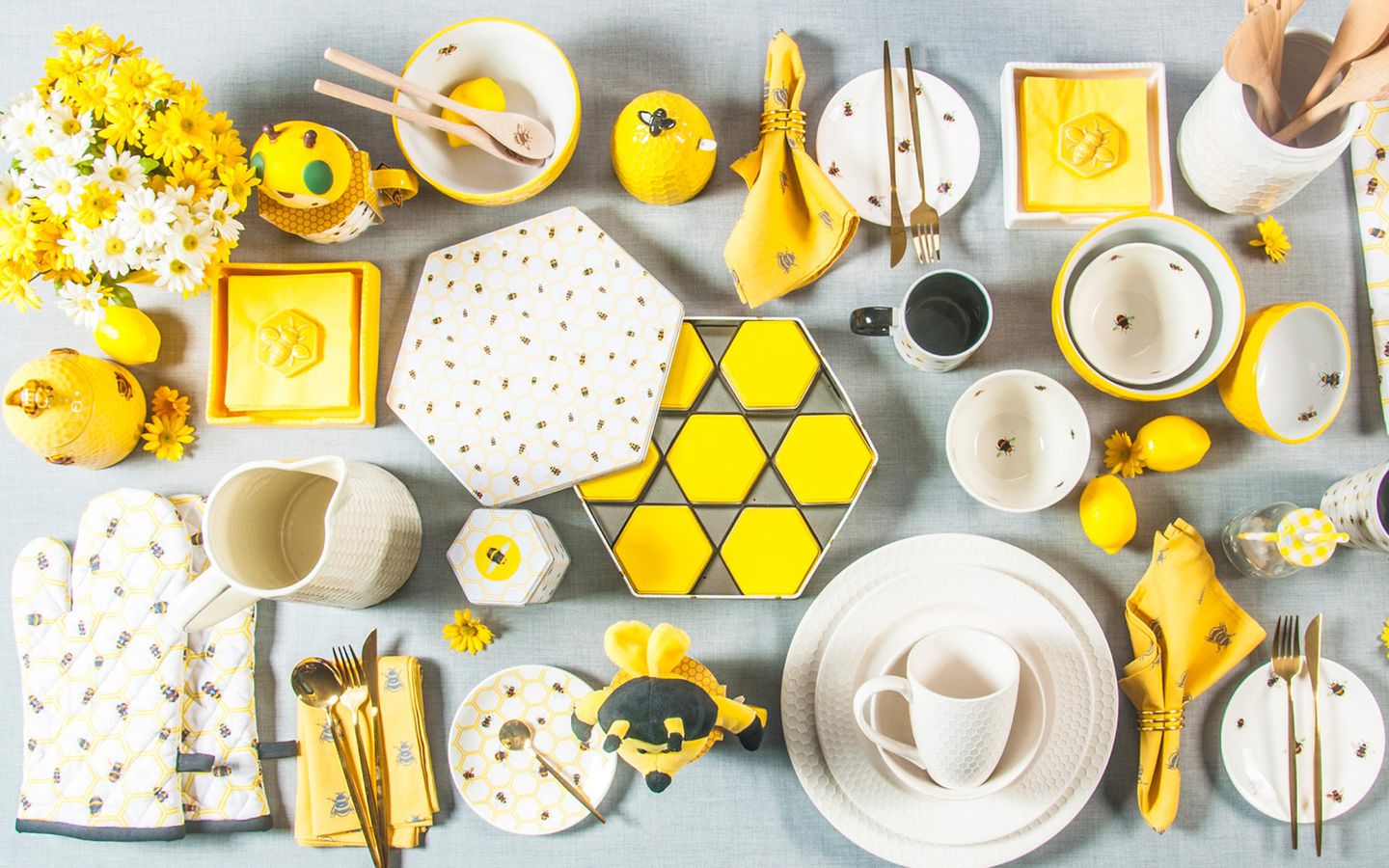 Bee-themed yellow and white ceramic tableware collection